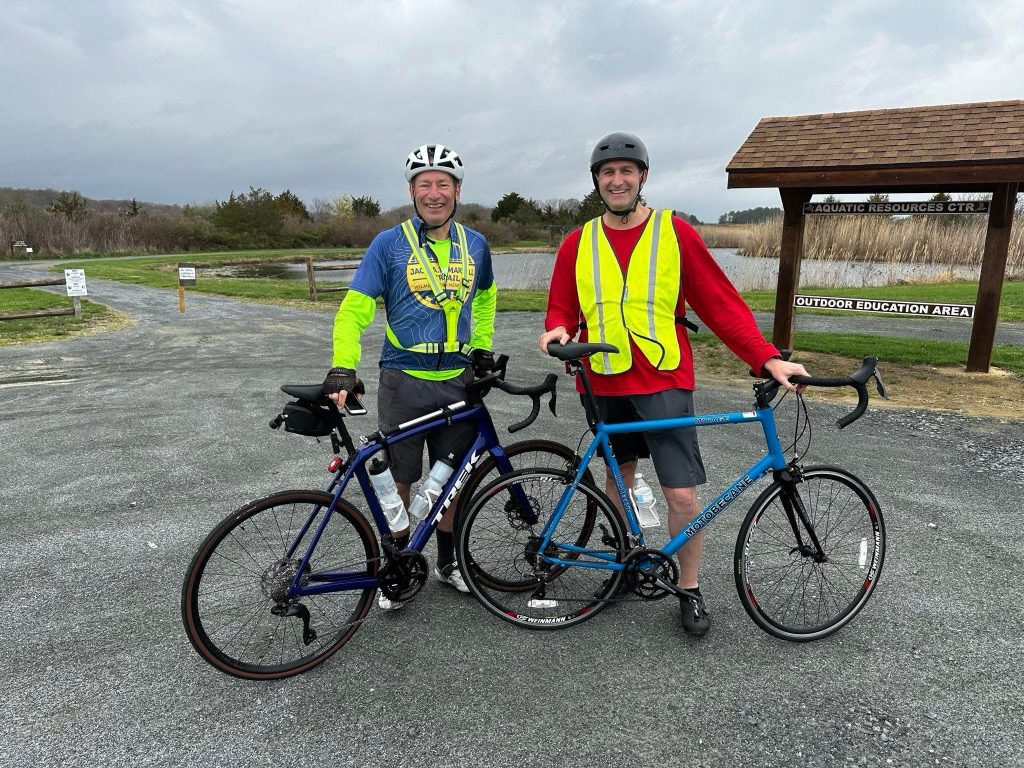 Governor Matt Meyer and another Delawarean standing outside with their bikes.