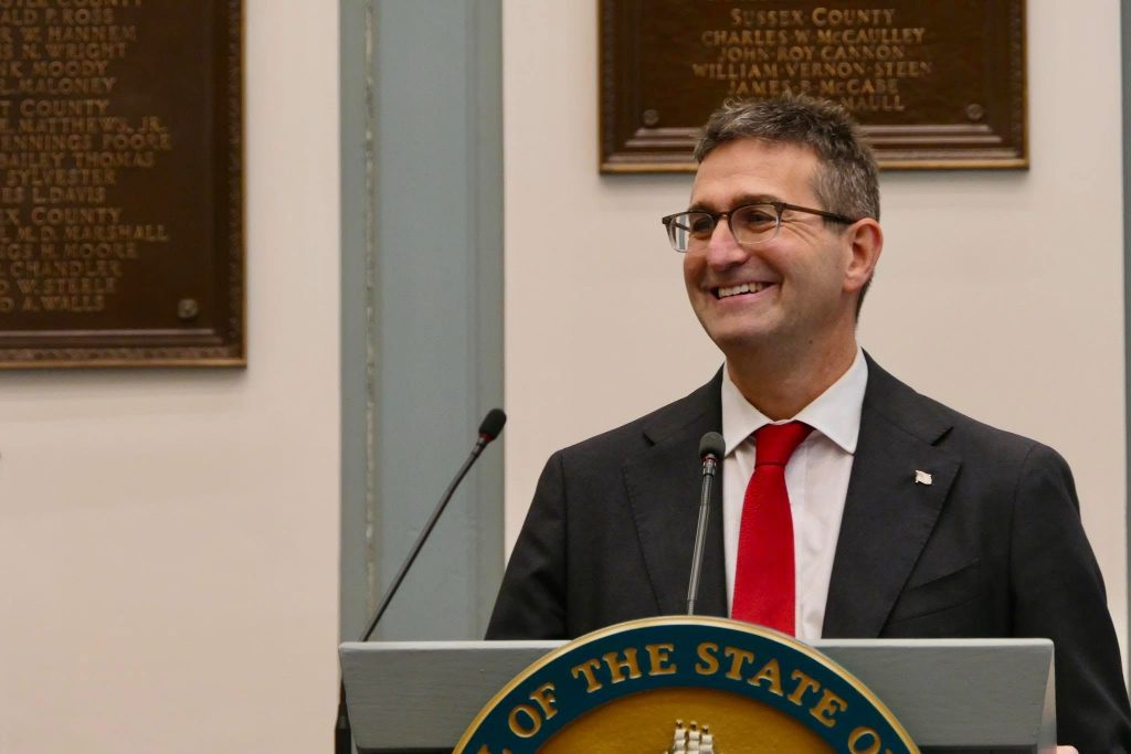 Governor Matt Meyer at a podium.