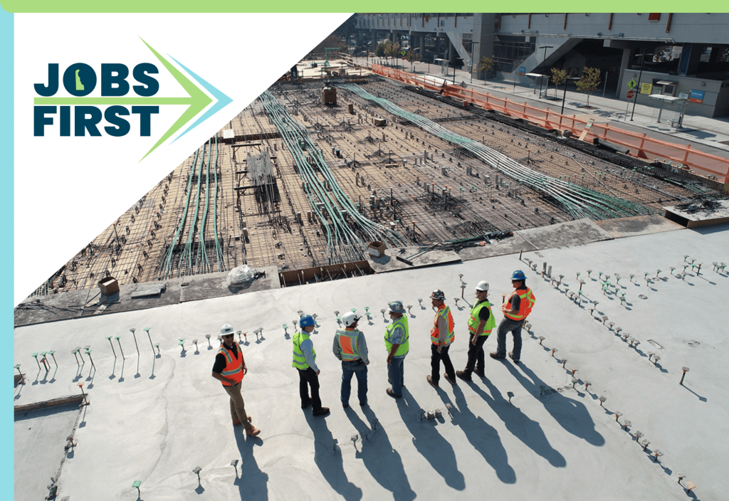 construction workers at a construction site. JobsFirst logo overlaying the image. 