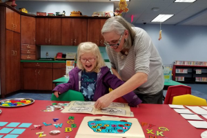 First Lady Tracey Quillen Carney working on an art project with a child