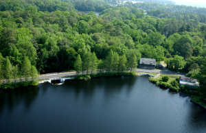 An ariel view of Betts Pond, with a road running over the dam.